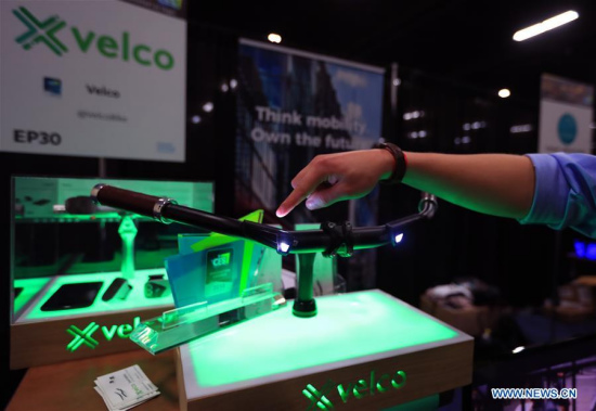 A staff member from Velco displays an intelligent handlebar during the preview media show of the Consumer Electronics Show (CES) in Las Vegas, the United States, Jan. 7, 2018. The Consumer Electronics Show (CES) will kick off on Jan. 9 in Las Vegas. (Xinhua/Li Ying)
