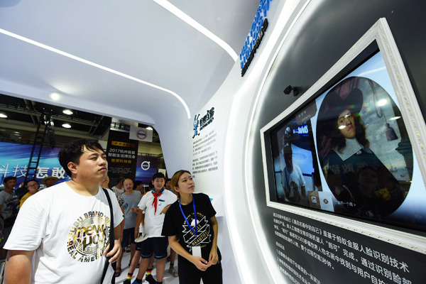 A visitor takes part in an interactive game supported by Ant Financial's facial recognition technology at a high-tech products exhibition in Hangzhou, Zhejiang province. (Photo by Long Wei/for China Daily)