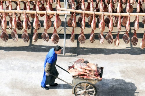 Jinhua ham is dried in the sun in Zhejiang Province. Selling on Tmall has helped boost annual sales growth of China's classic brands such as Jinhua Ham. (Photo by Qian Xudong/For China Daily)