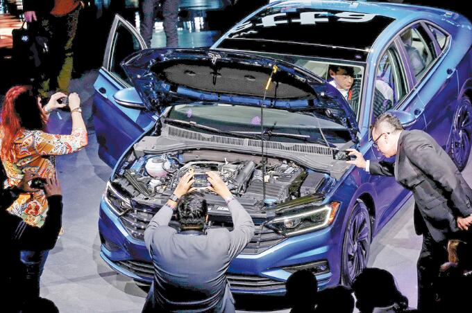 Guests photograph the 2019 Volkswagen Jetta as it is unveiled at the North American International Auto Show in Detroit, Michigan, in January this year. (Photo provided to China Daily)