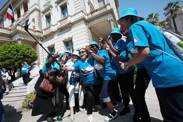 Tianjin-based Tiens Group's staff take a selfie in Nice, France, during a custom-designed company tour. (Photo provided to China Daily)