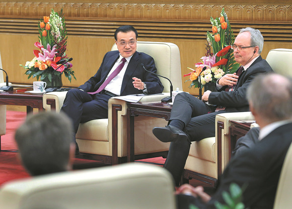 Premier Li Keqiang talks at a gathering of outstanding foreign experts working in China on Monday in the Great Hall of the People in Beijing. (WU ZHIYI / CHINA DAILY)