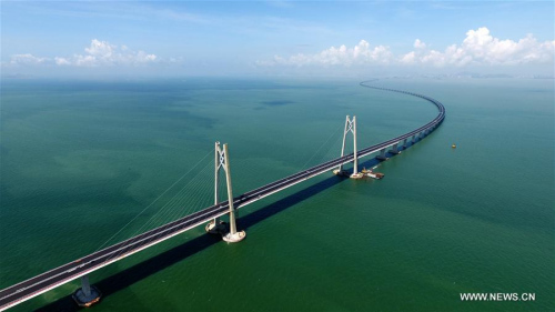 Photo taken on June 6, 2017 shows the Hong Kong-Zhuhai-Macao Bridge under construction. Major work on the 55-km-long Hong Kong-Zhuhai-Macao Bridge, the world's longest sea bridge, has passed authorities' evaluation. The huge project has been considered an engineering wonder and a magnificent feat of si-tech innovation. The bridge took six years of preparation, and eight years to build. Major work on the bridge consisted of a 22.9-km-long main bridge, a 6.7-km-long tunnel and an artificial island off the bridge, which was considered the most technically demanding part of the whole construction. The bridge will slash the travel time between Hong Kong and Zhuhai from three hours to just 30 minutes, further integrating cities in the Pearl River Delta. (Xinhua/Liang Xu)