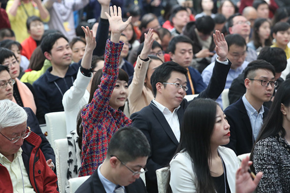 Reporters hope to be called on at a news conference for the first session of the 13th National Committee of the Chinese People's Political Consultative Conference at the Great Hall of the People in Beijing. The session begins on Saturday. (Photo/Xinhua