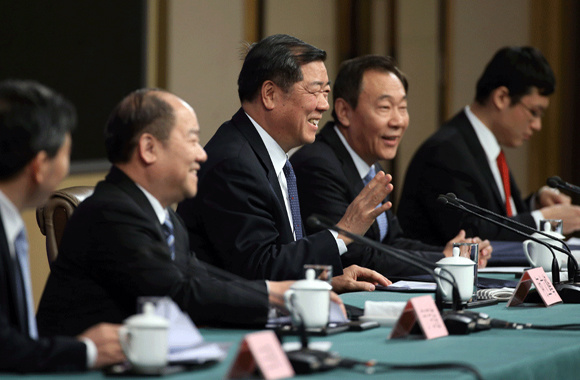 He Lifeng, minister of the National Development and Reform Commission, gestures to reporters on Tuesday. (Photo by Wang Zhuangfei/China Daily)