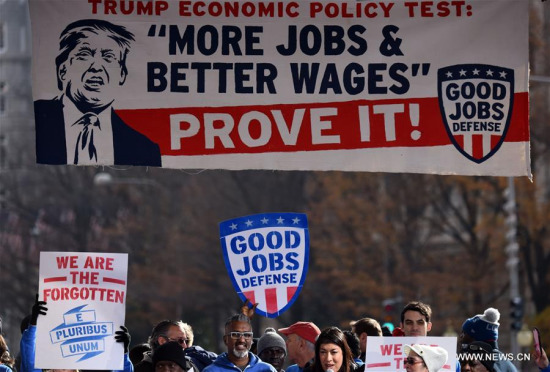 File photo taken on Dec. 7, 2016 shows people attending a rally calling for more jobs and better wages which was promised by Donald J. Trump during his campaign, in Washington D.C., the United States. With the United States retreating to the stronghold of protectionism and nationalism, concerns about a trade war are rising around the globe. (Xinhua/Yin Bogu)