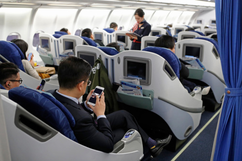 Passengers use mobile phones in airplane mode on a China Eastern Airlines passenger plane on Jan. 18. (Photo/China News Service)