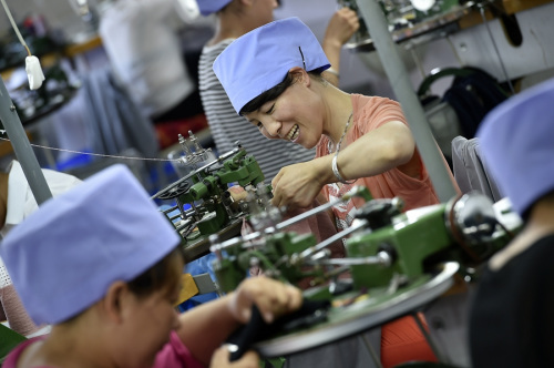 Women at work in a knitting factory in Jingling, a village in the Ningxia Hui autonomous region. The factory, which employs about 120 women, was brought into the village to tackle a lack of employment opportunities for female residents. (Photo/Xinhua)