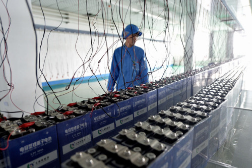 A worker checks facilities at a battery production line in Liaoning Province. (Photo/Xinhua)