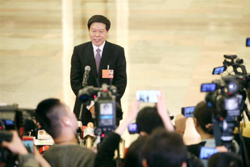 Director of China's State Administration of Taxation Wang Jun receives an interview after the fourth plenary meeting of the first session of the 13th National People's Congress at the Great Hall of the People in Beijing, March 13, 2018. (Photo/Xinhua)