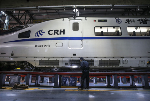 A worker checks the side of a bullet train in Nanning, Guangxi Zhuang autonomous region, on Feb 6. Chinese high-speed rail technology has gone global. (Photo/Xinhua)