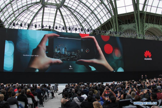 Guests and the media attend the launching ceremony of Huawei new smartphones held at the Grand Palais in Paris, France, March 27, 2018. China's technology giant Huawei launched its new generation of smartphones here on Tuesday. (Xinhua/Zhang Xuefei)
