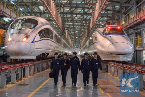 Yang Xue, Li Huihui, Chen Xuan, Chen Yingying and Rong Rong (L-R), who are members of the high-speed train maintenance staff at Hefei South Railway Station, are pictured at a service depot in Hefei, capital of east China's Anhui Province, March 6, 2018. (Xinhua/Guo Chen)