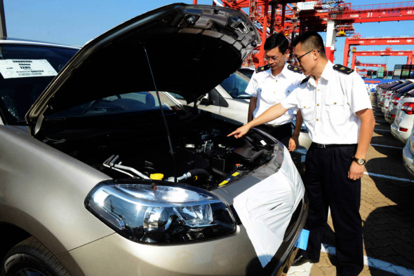 Inspectors check imported cars at Qingdao Port, Shandong province. (Photo by Yu Fangping/For China Daily)