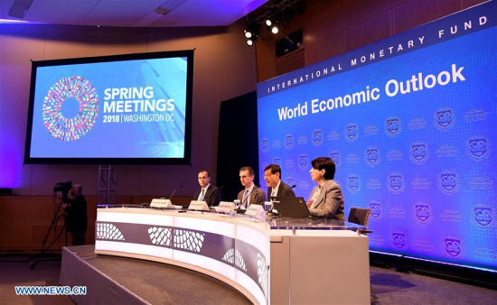 Maurice Obstfeld (2nd R), Economic Counsellor and Director of Research at the International Monetary Fund (IMF), speaks on the newly-released World Economic Outlook in Washington D.C., the United States, April 17, 2018. (Xinhua/Yang Chenglin)