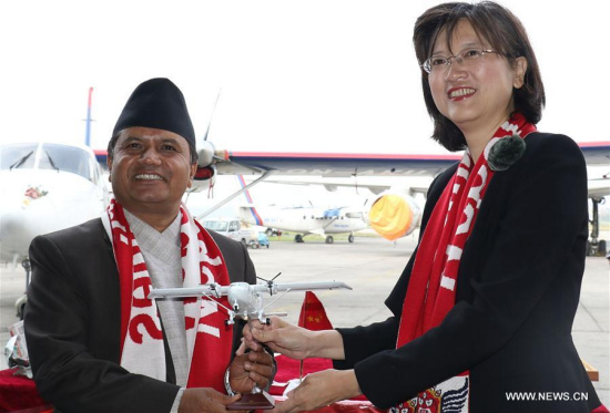 Nepalese Minister for Culture, Tourism and Civil Aviation Rabindra Prasad Adhikari (L) and Chinese Ambassador to Nepal Yu Hong attend the handover ceremony at the Tribhuvan International Airport in Kathmandu, Nepal. Nepal received two Y-12e planes as part of six-aircraft deal between Nepal and China. (Xinhua/Sunil Sharma)