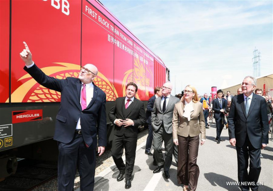 Austrian President Alexander Van der Bellen (1st R, Front), Austrian Minister for Digital and Economic Affairs Margarete Schrambock (2nd R, Front) and other guests inspect a new China-Europe freight train from Chengdu to Vienna at the Vienna South Freight Center in Vienna, Austria, on April 27, 2018. (Xinhua/Pan Xu)