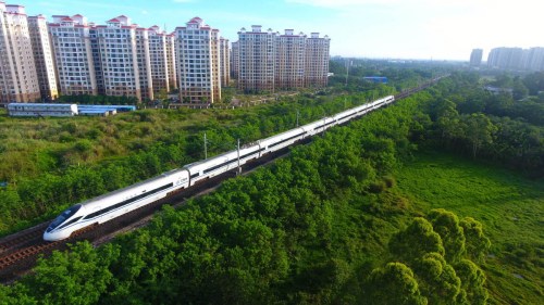 Photo taken on May 6, 2018 shows a bullet train running on the high-speed loop line near Qionghai city, South China's Hainan province. The 653-km high-speed railway line circling the island received over 25 million passengers in 2017. (Photo/Xinhua)