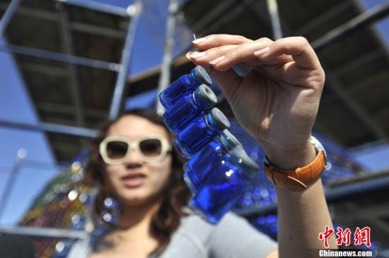 A tourist demonstrates the recycled bottles to form part of the lanterns.