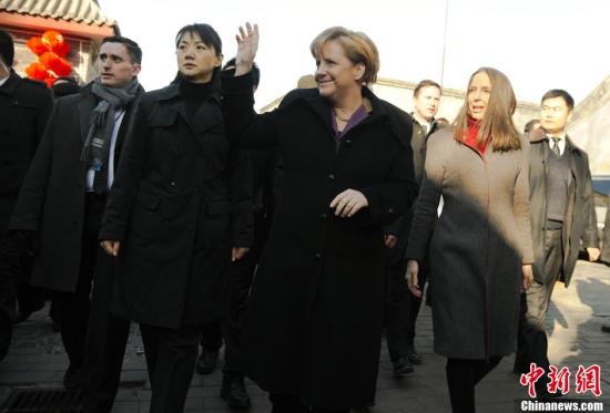 On Thursday afternoon, German Chancellor Angela Merkel paid a visit to Nan Luo Gu Xiang, an hisctorical and cultural street in ancient Beijing's downtown area. Merkel says hello to local residents.
