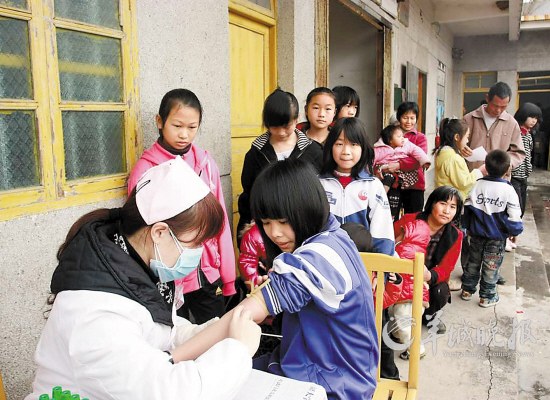 Children in queue for the government-organized physical check, February [File photo]