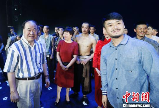Mo Yan meets actors after Qingdao Song & Dance Theatre put on the second performance of Red Sorghum on Sunday night.[Chinanews.com]