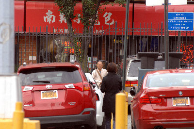 A monk begs for alms on a street.