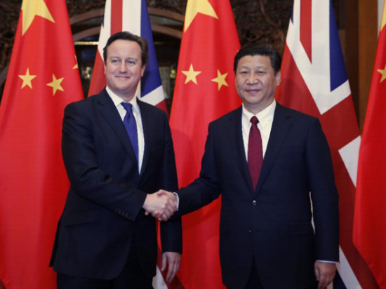 Chinese President Xi Jinping (R) shakes hands with visiting British Prime Minister David Cameron during their meeting in Beijing, capital of China, Dec. 2, 2013.(Xinhua/Ju Peng) 