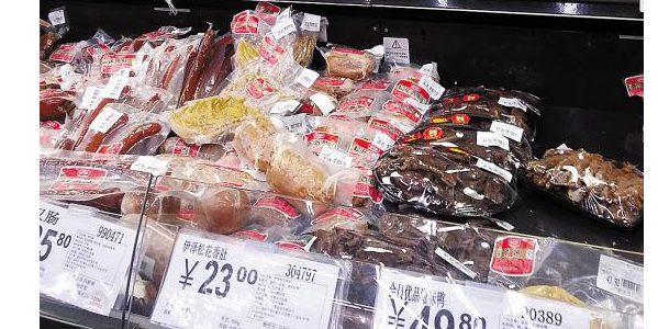 Cooked meat packages are seen in a supermarket.