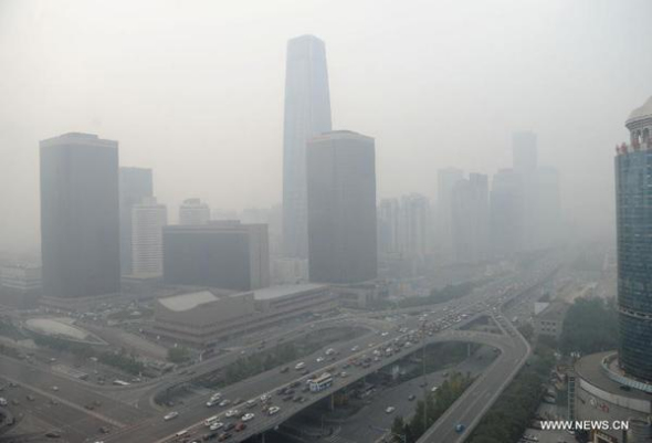 Buildings are blanketed in heavy smog near Guomao Bridge in Beijing, capital of China, Oct 28, 2013. (Xinhua/Luo Xiaoguang)