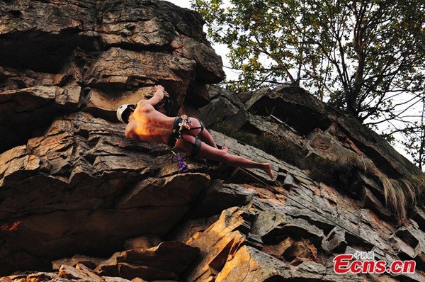 Chinese climber Li Tongxing succeeds in climbing a 100-meter-high peak nakedly in Zhangjiajie of central China's Hunan province on Jan. 25, 2014. [Photo/Zhang Mingtao]