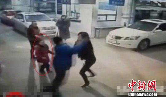 The five-year-old girl moves forward to protect her mother from violent attack in the screenshot of video.