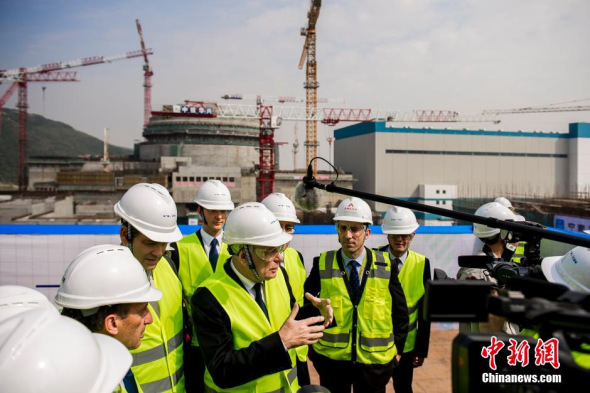 French Prime Minister Jean-Marc Ayrault visits the construction sites of Taishan Nuclear Power Plant, the largest co-invested nuclear power project by France and China, outside Taishan City in Guandong province in December 2013. [Photo: China News Service / Long Yuyang]