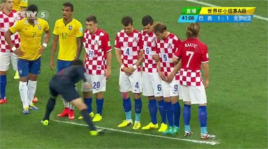 The referee uses the special spray to paint a temporary line 9.15 meters from the free kick spot. [PhotoScreenshot of the game]