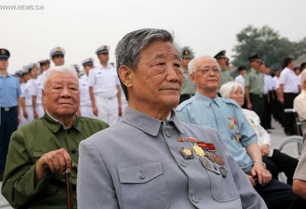 Veterans attend a grand gathering to mark the 77th anniversary of the beginning of the Chinese People's War of Resistance Against Japanese Aggressions at the Museum of the Chinese People's War of Resistance Against Japanese Aggressions in Beijing, July 7, 2014. [Photo/Xinhua]