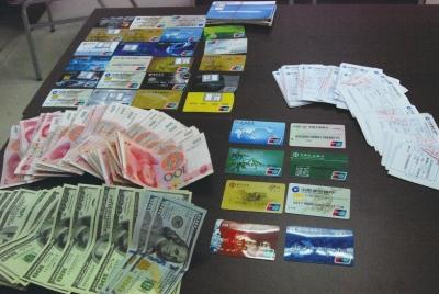 Money and bank cards Beijing police have seized during the crackdown. (Photo: the Beijing Time)