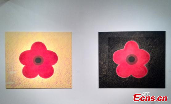 Two of professor Kim Byung-jong's paintings featuring red flowers are displayed at Today Art Museum. [Photo/Ecns]
