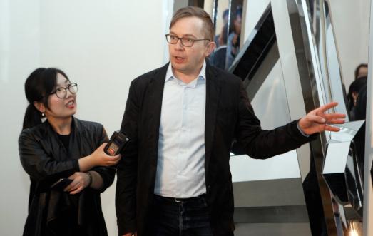 German artist Dieter Detzner makes a presentation of his artwork Sunday at Today Art Museum. (Photo courtesy of Today Art Museum) 