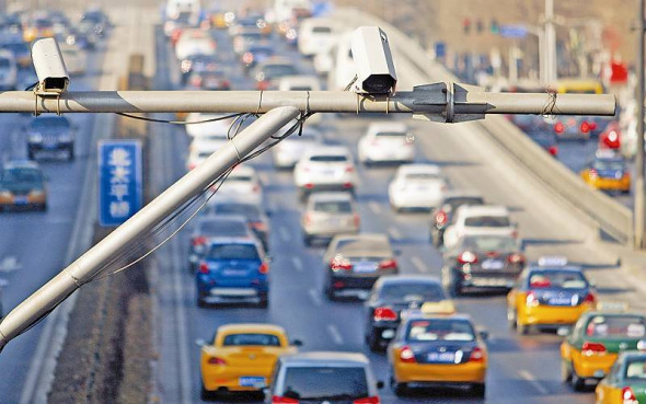 Surveillance cameras are seen over a road in Beijing. (File photo)