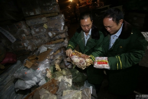 Inspectors check frozen meat seized in Shenzhen, Guangdong province, April 15, 2015. (Photo/Beijing News)