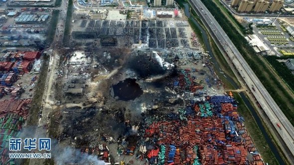 An aerial photograph taken on Aug 16, 2015 shows a huge hole at the center of the site of a series of explosions in North China’s Tianjin municipality. (Photo