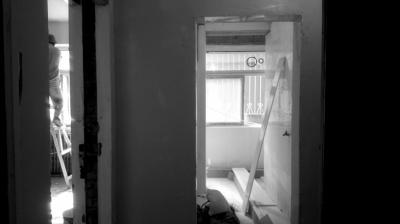 Workers renovate the house after Mr. Li moves out.