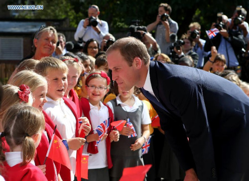 File photo taken on Sept 8, 2014 shows Prince William (R), Duke of Cambridge, speaking with school students as he arrives to formally inaugurate the Dickson Poon University of Oxford China Centre Building in Oxford, Britain. (Photo: Xinhua/Han Yan)