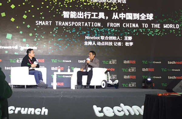 Ninebot co-founder Wang Ye (R) speaks at a Tech Crunch panel on smart transportation in Beijing, Nov. 2, 2015. (Photo provided to ECNS)