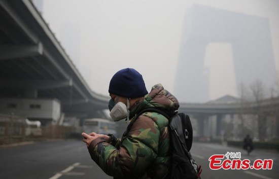 A man wearing a facial mask stands on a street in Beijing, on Dec. 8.(CNS photo/Yang Kejia)