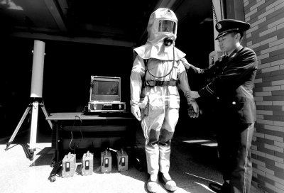 An armed police officer shows newly-developed firefighting gear. (Photo/Beijing Times)