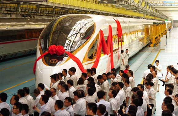 People attend a naming ceremony for the new models of China's electric multiple unit (EMU) train Fuxing in Beijing, capital of China, June 25, 2017. (Xinhua/Xing Guangli)