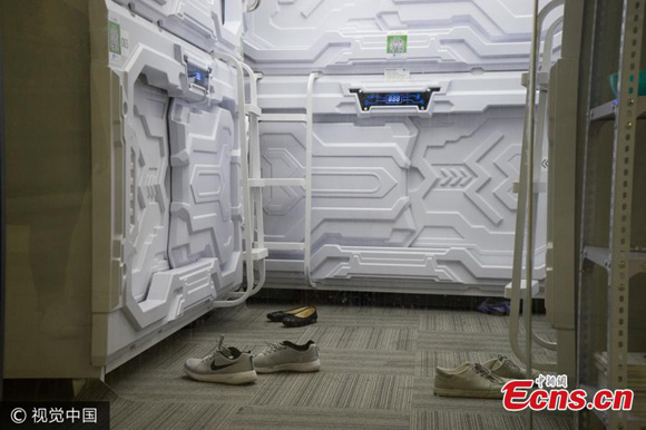 Shoes of users are seen near sleep capsules in the business incubator area of Haidian District, Beijing, July 9, 2017.  (Photo/VCG) 