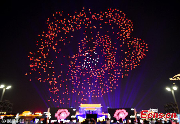 Drones make a formation in the air over the illuminated Yongning Gate in Xi'an City, capital of Northwest China's Shaanxi Province, May 1, 2018. (Photo/VCG)