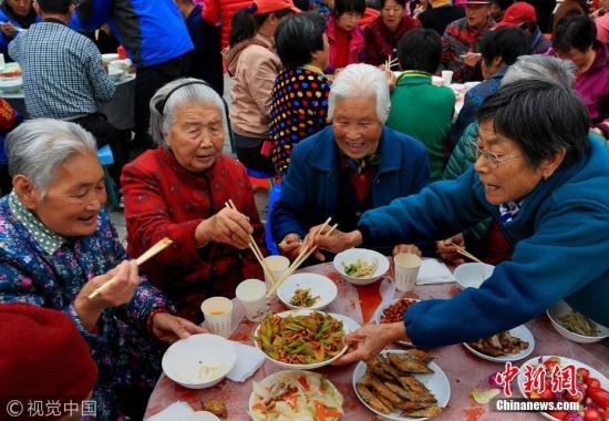 Senior people get together at a Hundred-family banquet in Beijing during the Chongyang Festival. (File photo/VCG)